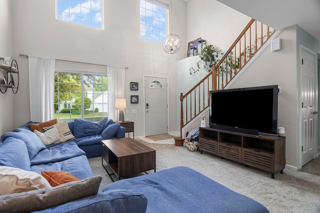 1585 Belle Haven Dr, Grayslake, IL 60030 - carpeted living room with healthy amount of natural light, stairway, a high ceiling, a chandelier, and baseboards