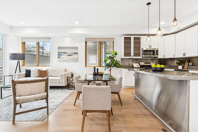 921 N Honore St Unit B, Chicago, IL 60622 - kitchen with stainless steel appliances, white cabinets, light wood-type flooring, glass insert cabinets, and recessed lighting