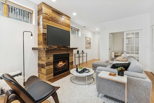 921 N Honore St Unit B, Chicago, IL 60622 - living room featuring wood finished floors, recessed lighting, a warm lit fireplace, and baseboards
