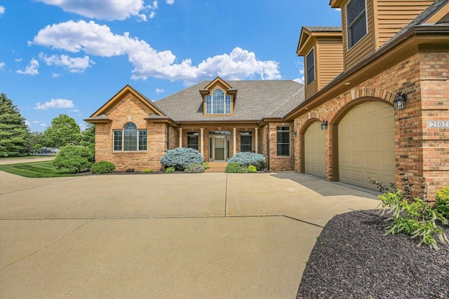 2502 Prairie Ridge Pl, Champaign, IL 61822 - view of front of home with driveway, brick siding, and roof with shingles
