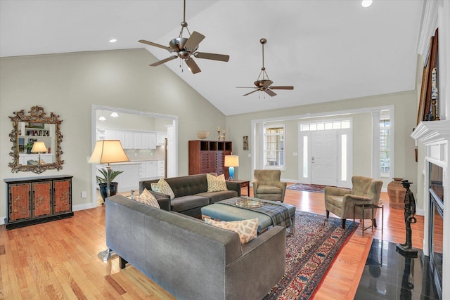 2502 Prairie Ridge Pl, Champaign, IL 61822 - living room with high vaulted ceiling, a ceiling fan, baseboards, light wood-style flooring, and recessed lighting