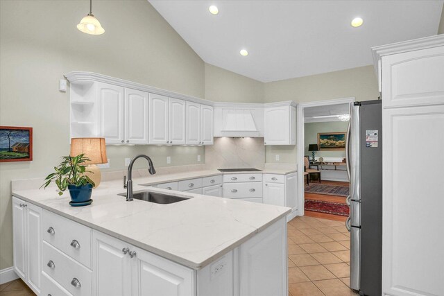 2502 Prairie Ridge Pl, Champaign, IL 61822 - kitchen featuring a sink, freestanding refrigerator, vaulted ceiling, white cabinets, and black electric stovetop