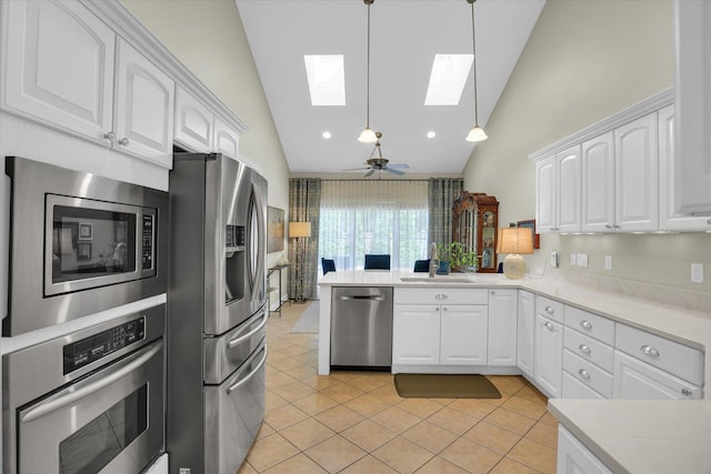 2502 Prairie Ridge Pl, Champaign, IL 61822 - kitchen with appliances with stainless steel finishes, a sink, a skylight, white cabinets, and high vaulted ceiling