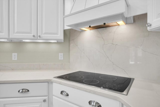 2502 Prairie Ridge Pl, Champaign, IL 61822 - kitchen featuring black electric stovetop, custom range hood, white cabinets, and decorative backsplash