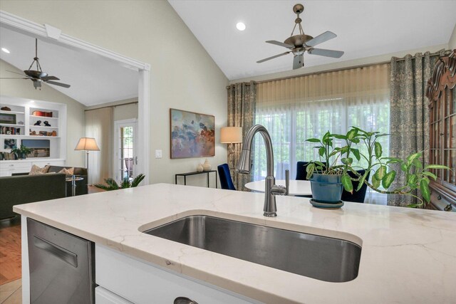 2502 Prairie Ridge Pl, Champaign, IL 61822 - kitchen with vaulted ceiling, a sink, a ceiling fan, light stone countertops, and white cabinets