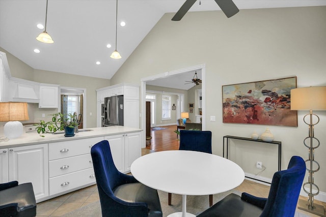 2502 Prairie Ridge Pl, Champaign, IL 61822 - dining area featuring a ceiling fan, high vaulted ceiling, light tile patterned flooring, and recessed lighting