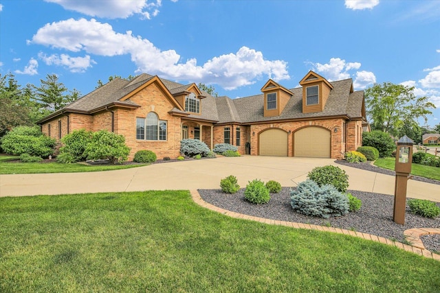 2502 Prairie Ridge Pl, Champaign, IL 61822 - view of front of home featuring concrete driveway, brick siding, a front yard, and roof with shingles