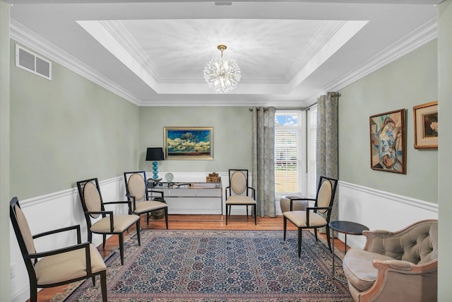2502 Prairie Ridge Pl, Champaign, IL 61822 - sitting room with wood finished floors, ornamental molding, a chandelier, a raised ceiling, and wainscoting