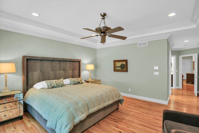 2502 Prairie Ridge Pl, Champaign, IL 61822 - bedroom featuring crown molding, a tray ceiling, baseboards, light wood-style flooring, and recessed lighting