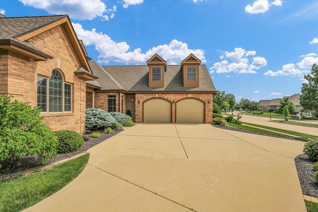 2502 Prairie Ridge Pl, Champaign, IL 61822 - view of front of house featuring brick siding, concrete driveway, an attached garage, and a shingled roof