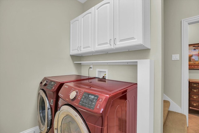 2502 Prairie Ridge Pl, Champaign, IL 61822 - laundry area featuring independent washer and dryer, cabinet space, baseboards, and light tile patterned flooring