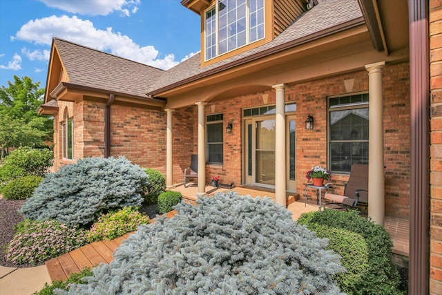 2502 Prairie Ridge Pl, Champaign, IL 61822 - doorway to property with covered porch, roof with shingles, and brick siding
