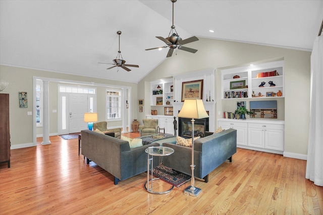 2502 Prairie Ridge Pl, Champaign, IL 61822 - living room with built in features, light wood finished floors, baseboards, ceiling fan, and high vaulted ceiling