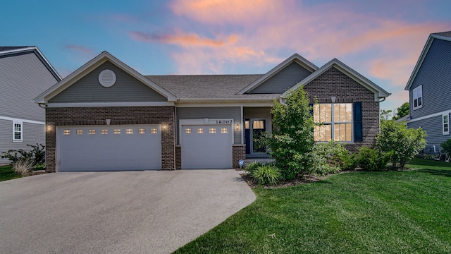 16002 S Selfridge Cir, Plainfield, IL 60586 - view of front facade with brick siding, a front lawn, driveway, and a garage