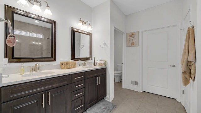16002 S Selfridge Cir, Plainfield, IL 60586 - bathroom featuring double vanity, toilet, tile patterned floors, and a tile shower
