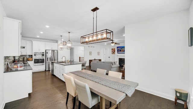 16002 S Selfridge Cir, Plainfield, IL 60586 - dining area featuring a ceiling fan, dark wood-style floors, a fireplace, recessed lighting, and baseboards