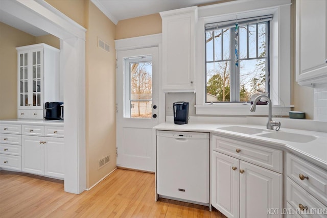 352 Elm St, Batavia, IL 60510 - kitchen featuring white dishwasher, a sink, light wood finished floors, and plenty of natural light