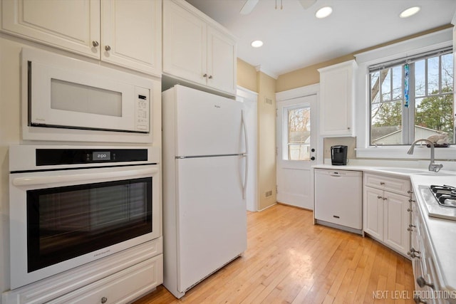 352 Elm St, Batavia, IL 60510 - kitchen with white appliances, a sink, recessed lighting, white cabinets, and light wood-style floors