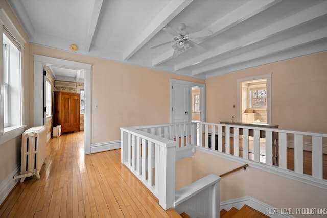 352 Elm St, Batavia, IL 60510 - corridor featuring radiator, an upstairs landing, beamed ceiling, light wood-style floors, and baseboards
