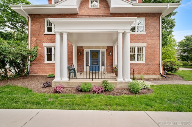 352 Elm St, Batavia, IL 60510 - entrance to property featuring covered porch, brick siding, and a chimney