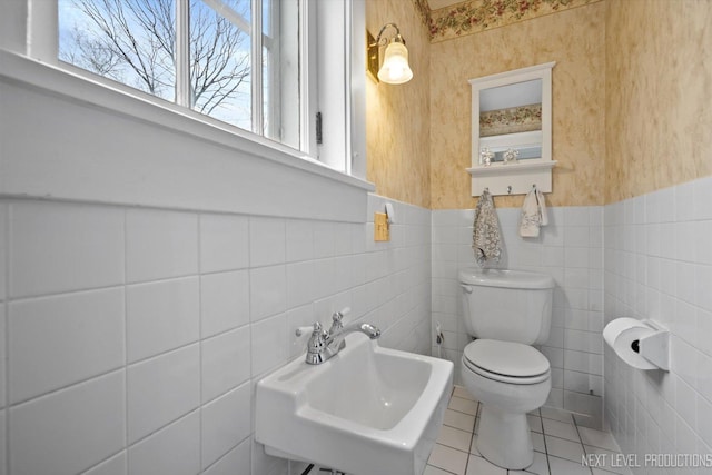 352 Elm St, Batavia, IL 60510 - half bath with toilet, a sink, tile patterned flooring, tile walls, and a wainscoted wall