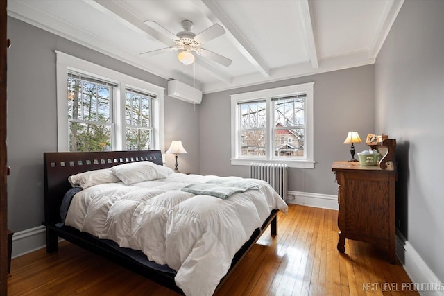 352 Elm St, Batavia, IL 60510 - bedroom featuring radiator heating unit, multiple windows, a wall mounted air conditioner, light wood-style flooring, and beamed ceiling