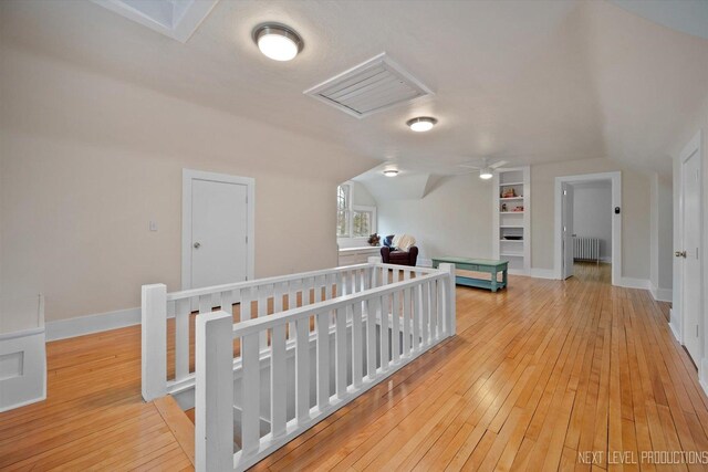 352 Elm St, Batavia, IL 60510 - hallway featuring radiator, light wood-style floors, lofted ceiling, and baseboards