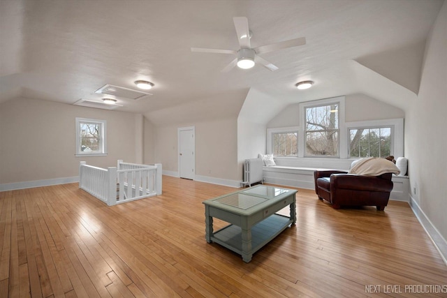 352 Elm St, Batavia, IL 60510 - additional living space with radiator heating unit, lofted ceiling, healthy amount of natural light, and light wood finished floors