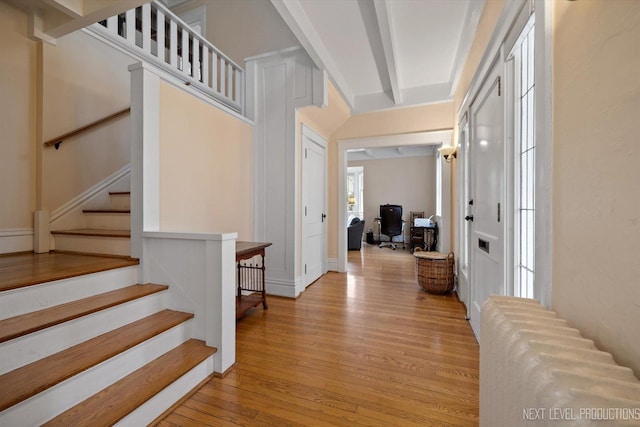 352 Elm St, Batavia, IL 60510 - entrance foyer featuring light wood-style flooring, radiator heating unit, and stairway