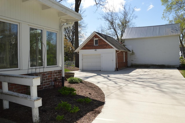 352 Elm St, Batavia, IL 60510 - view of side of property featuring a garage, an outbuilding, and driveway
