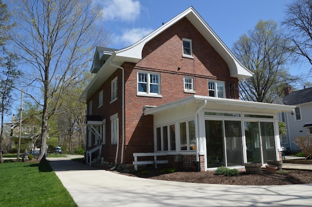 352 Elm St, Batavia, IL 60510 - view of home's exterior with a sunroom and brick siding