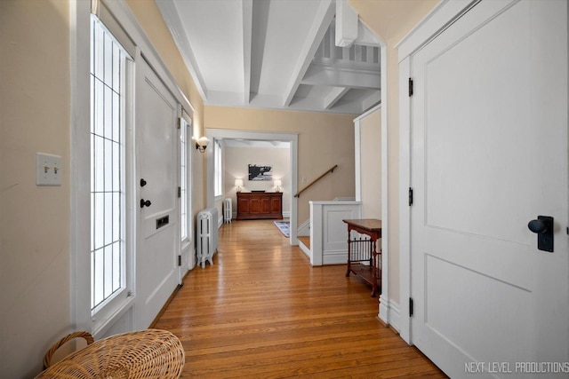 352 Elm St, Batavia, IL 60510 - hallway featuring radiator heating unit, light wood-style flooring, beam ceiling, healthy amount of natural light, and stairway