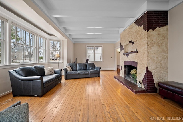 352 Elm St, Batavia, IL 60510 - living room with beam ceiling, a large fireplace, light wood-style floors, and baseboards