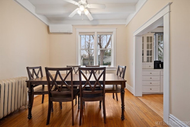 352 Elm St, Batavia, IL 60510 - dining space featuring radiator heating unit, an AC wall unit, light wood-type flooring, ceiling fan, and beamed ceiling