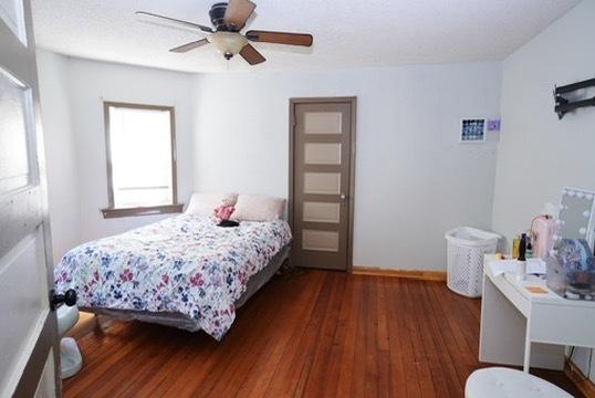 1711 S 4th St, Rockford, IL 61104 - bedroom featuring wood finished floors, ceiling fan, and baseboards