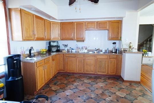 1711 S 4th St, Rockford, IL 61104 - kitchen featuring a ceiling fan, a sink, light countertops, and brown cabinetry