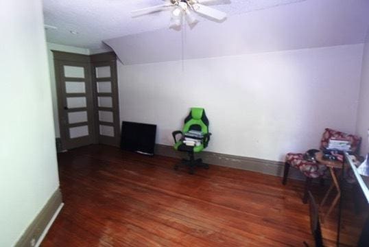 1711 S 4th St, Rockford, IL 61104 - bonus room featuring wood finished floors, a ceiling fan, and baseboards