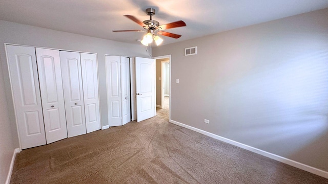 22500 Pleasant Dr, Richton Park, IL 60471 - unfurnished bedroom with two closets, baseboards, carpet, and a ceiling fan