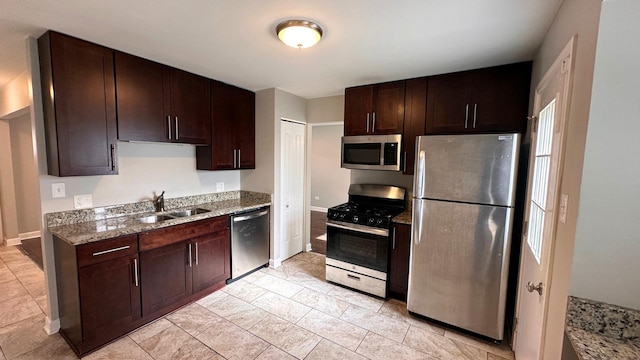 22500 Pleasant Dr, Richton Park, IL 60471 - kitchen with stainless steel appliances, a sink, dark brown cabinetry, and light stone countertops