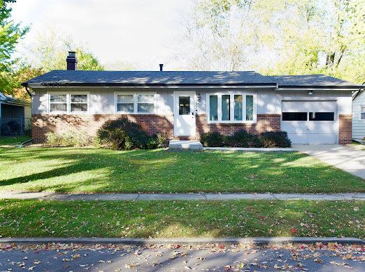 1216 Townley Dr, Bloomington, IL 61704 - ranch-style house featuring brick siding, a garage, a front yard, a chimney, and concrete driveway