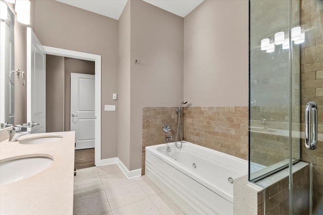 6 N May St Unit 403, Chicago, IL 60607 - full bathroom featuring a jetted tub, a stall shower, tile patterned floors, double vanity, and baseboards