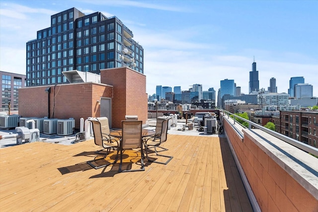 6 N May St Unit 403, Chicago, IL 60607 - wooden deck featuring a view of skyline, central air condition unit, and outdoor dining area