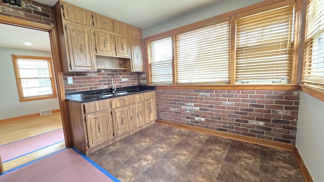 3544 Louis St, Franklin Park, IL 60131 - kitchen featuring dark countertops, baseboards, a sink, and tasteful backsplash