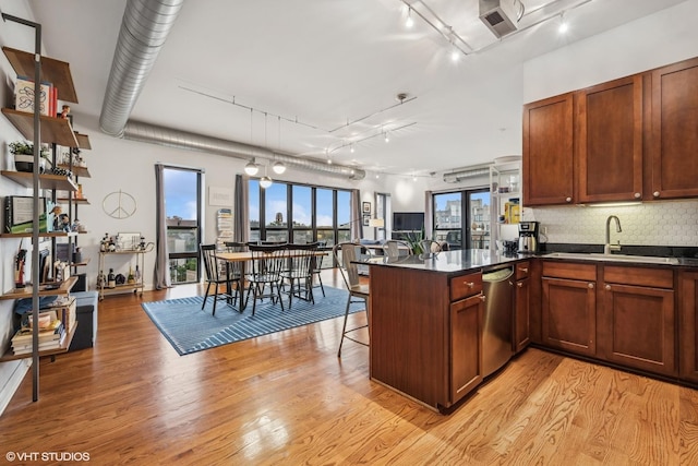 4020 N Damen Ave Unit 408, Chicago, IL 60618 - kitchen featuring a sink, rail lighting, a peninsula, dark countertops, and stainless steel dishwasher