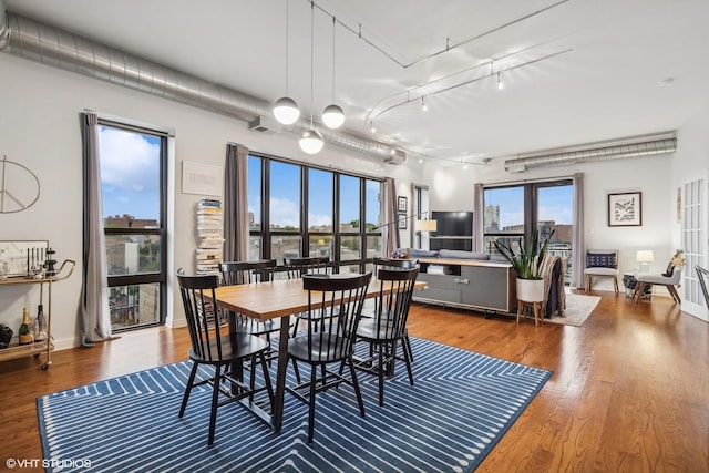 4020 N Damen Ave Unit 408, Chicago, IL 60618 - dining space with rail lighting and wood finished floors