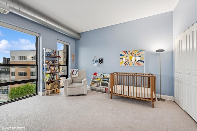 4020 N Damen Ave Unit 408, Chicago, IL 60618 - carpeted bedroom featuring a nursery area and baseboards