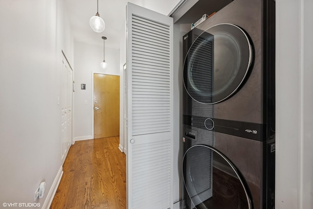 4020 N Damen Ave Unit 408, Chicago, IL 60618 - laundry room featuring stacked washer / dryer, wood finished floors, and baseboards