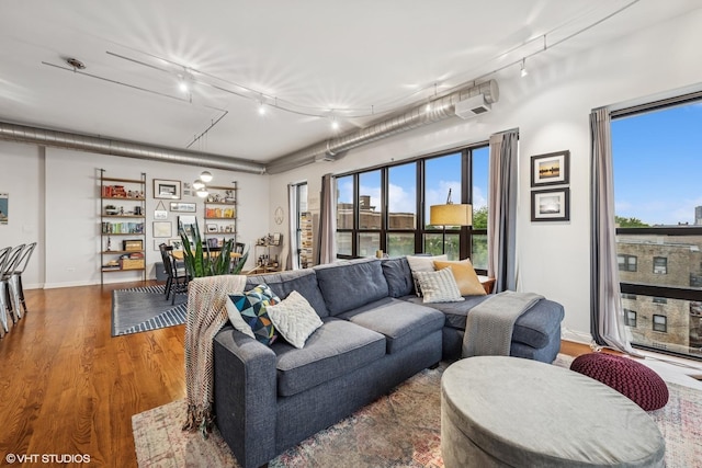 4020 N Damen Ave Unit 408, Chicago, IL 60618 - living room with rail lighting, wood finished floors, healthy amount of natural light, and baseboards