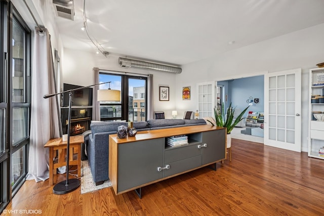 4020 N Damen Ave Unit 408, Chicago, IL 60618 - living area featuring wood finished floors, french doors, and rail lighting