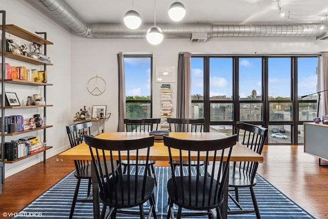 4020 N Damen Ave Unit 408, Chicago, IL 60618 - dining space featuring wood finished floors, healthy amount of natural light, and track lighting